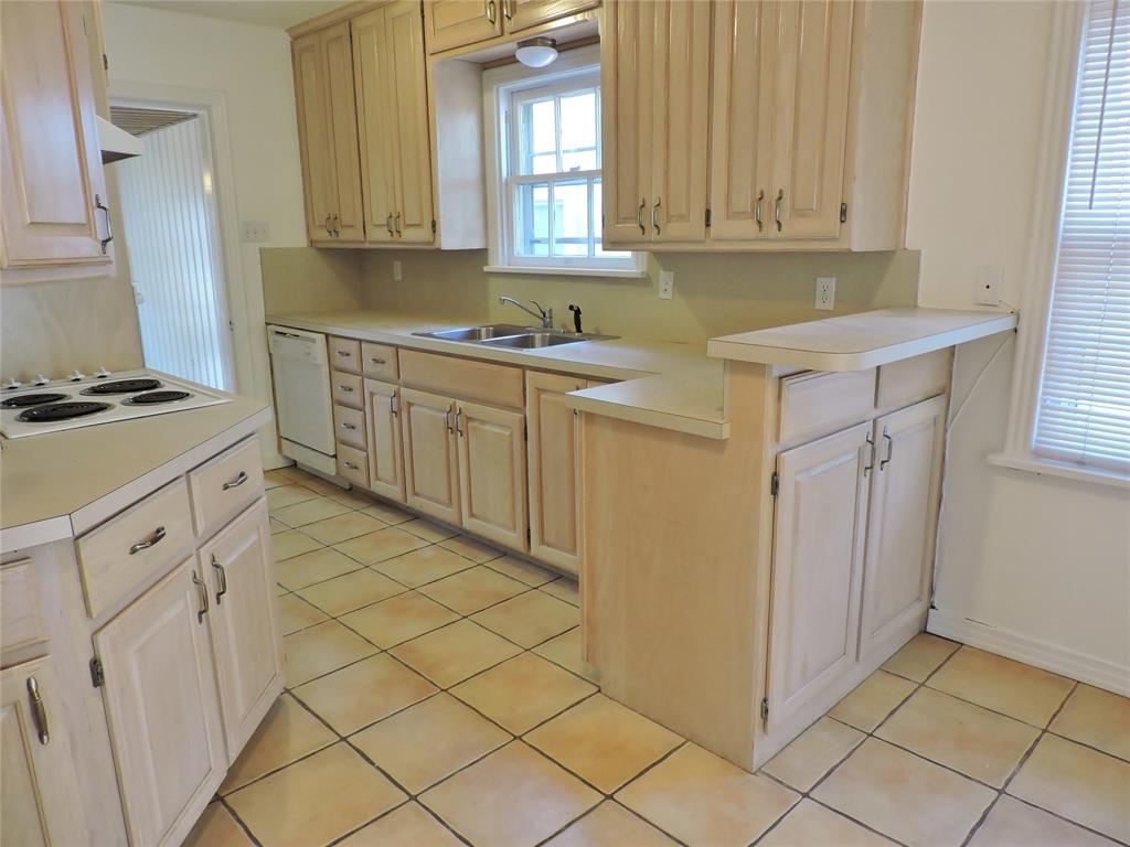 3425 Westcliff Road South Fort Worth, TX 76109 - Photo 8 of 22 Kitchen featuring light brown cabinets, light tile patterned floors, light countertops, and white appliances