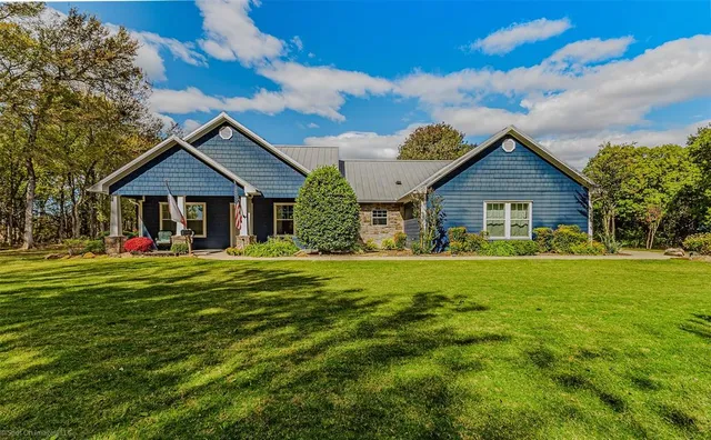 a front view of a house with a garden