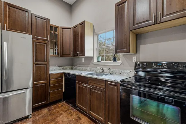 a kitchen with stainless steel appliances granite countertop a stove and a refrigerator