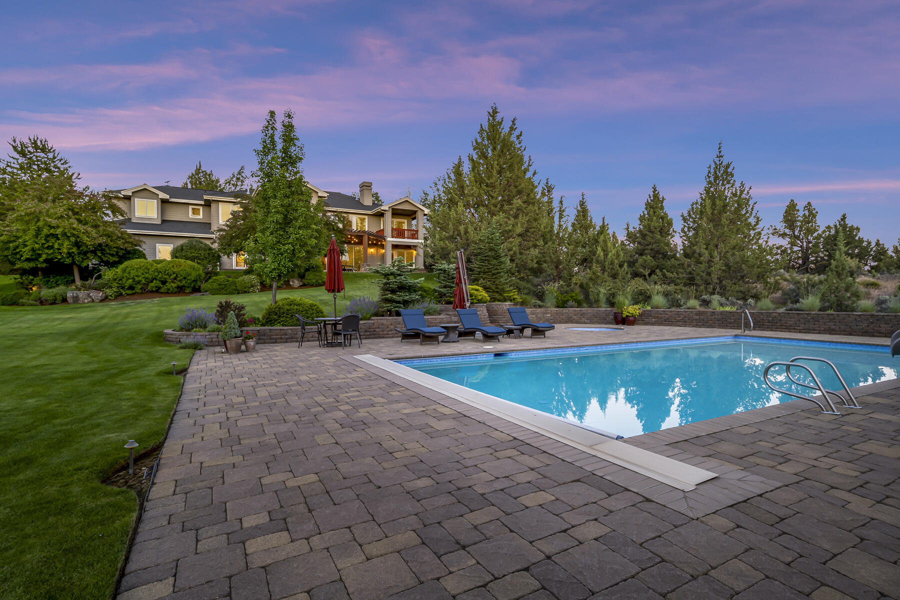 61445 Gosney Road Bend, OR 97702 - Photo 24 of 83 a view of a swimming pool and trees in the background