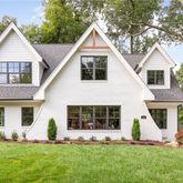 a front view of a house with a yard and porch
