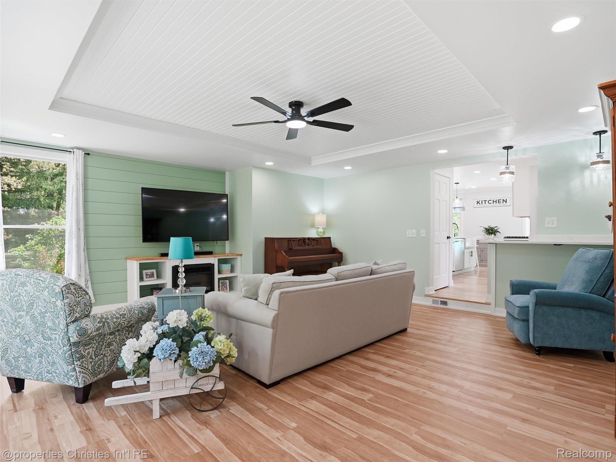 8645 Toma Road Pinckney, MI 48169 - Photo 17 of 65 Great room with shiplap and tray ceiling, electric fireplace