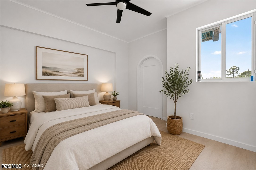 2665 Oil Well Road Naples, FL 34120 - Photo 27 of 40 a bedroom with bed and a potted plant