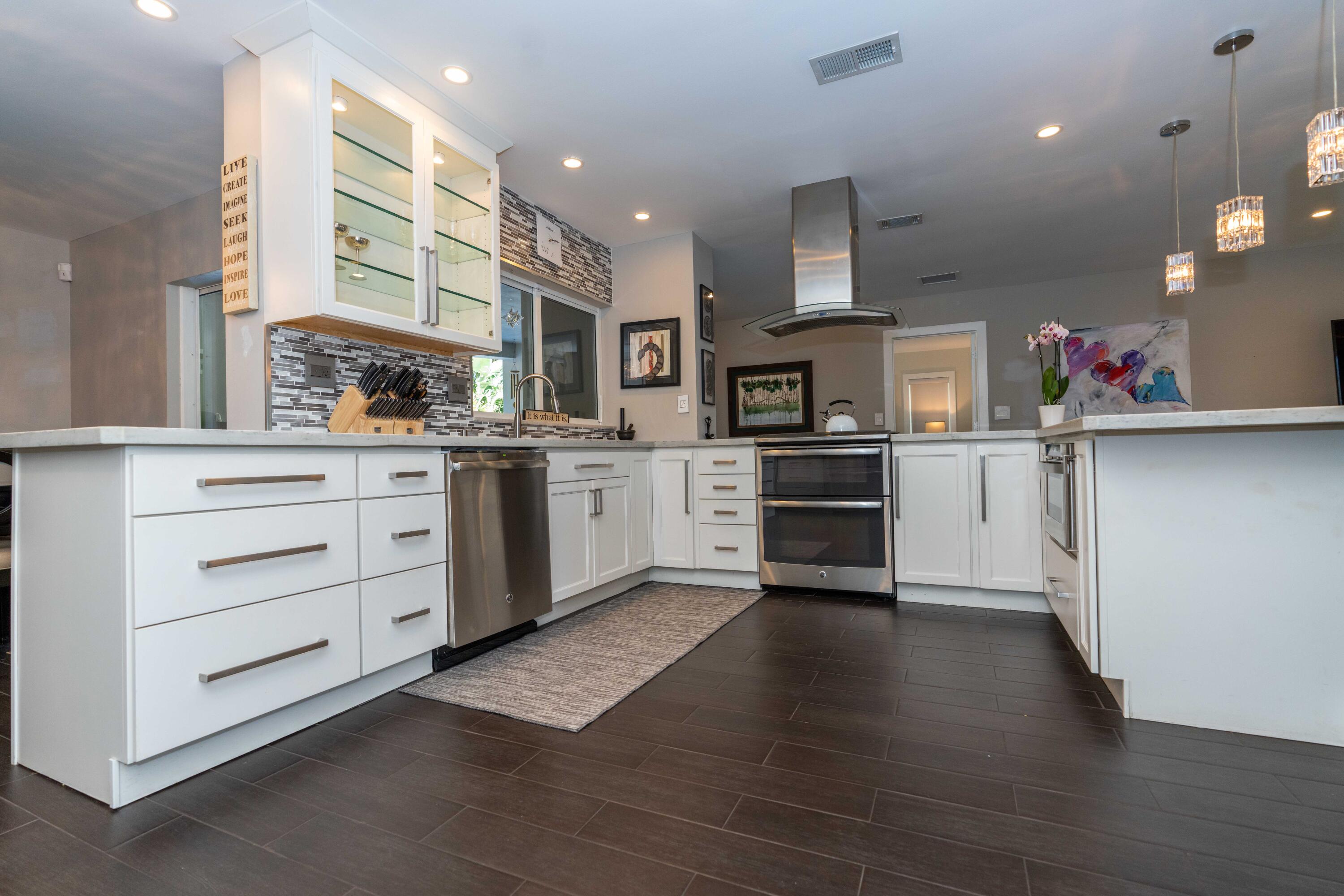 855 Berkley Street Boca Raton, FL 33487 - Photo 11 of 31 a kitchen with granite countertop white cabinets and stainless steel appliances