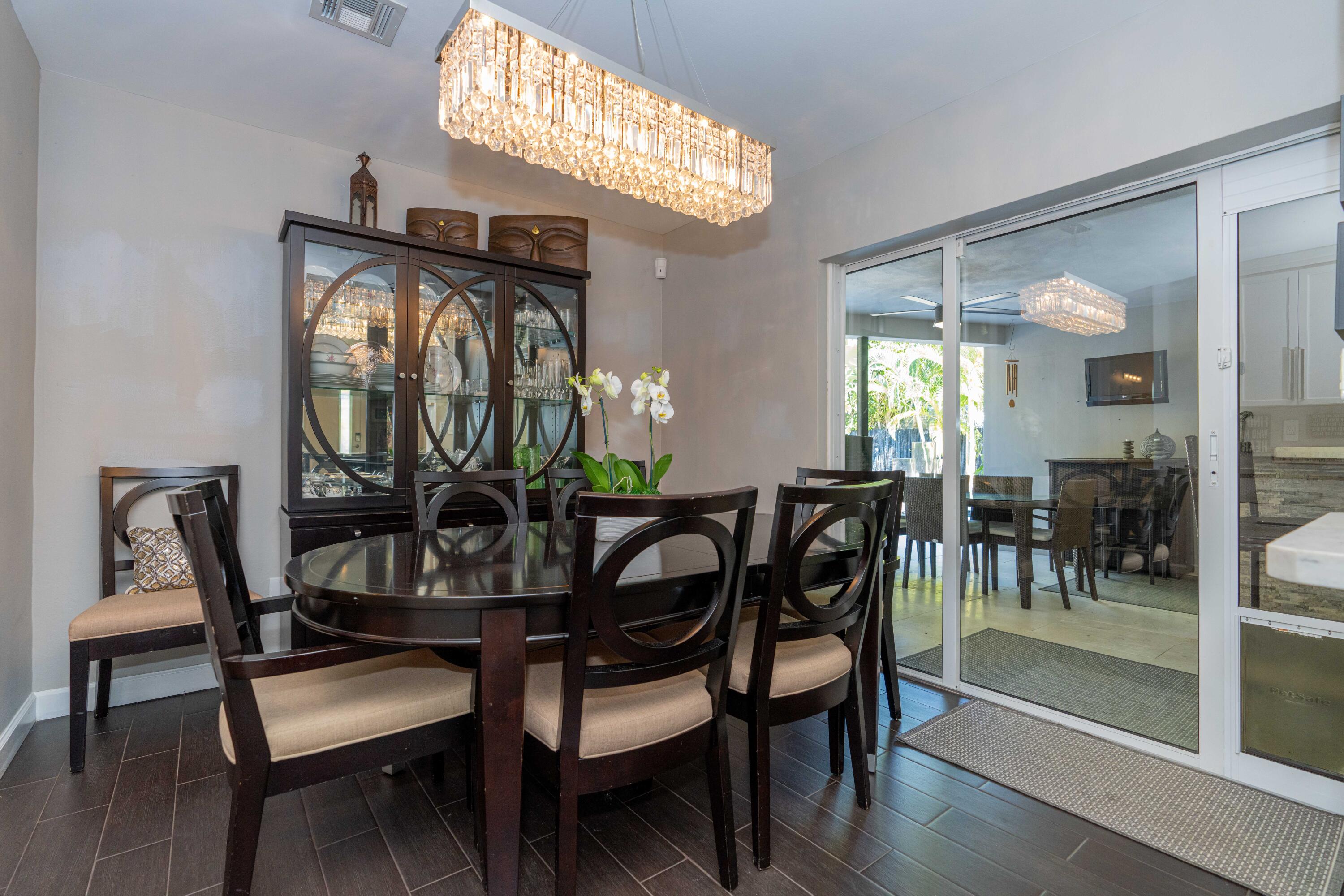 855 Berkley Street Boca Raton, FL 33487 - Photo 13 of 31 a view of a dining room with furniture and wooden floor