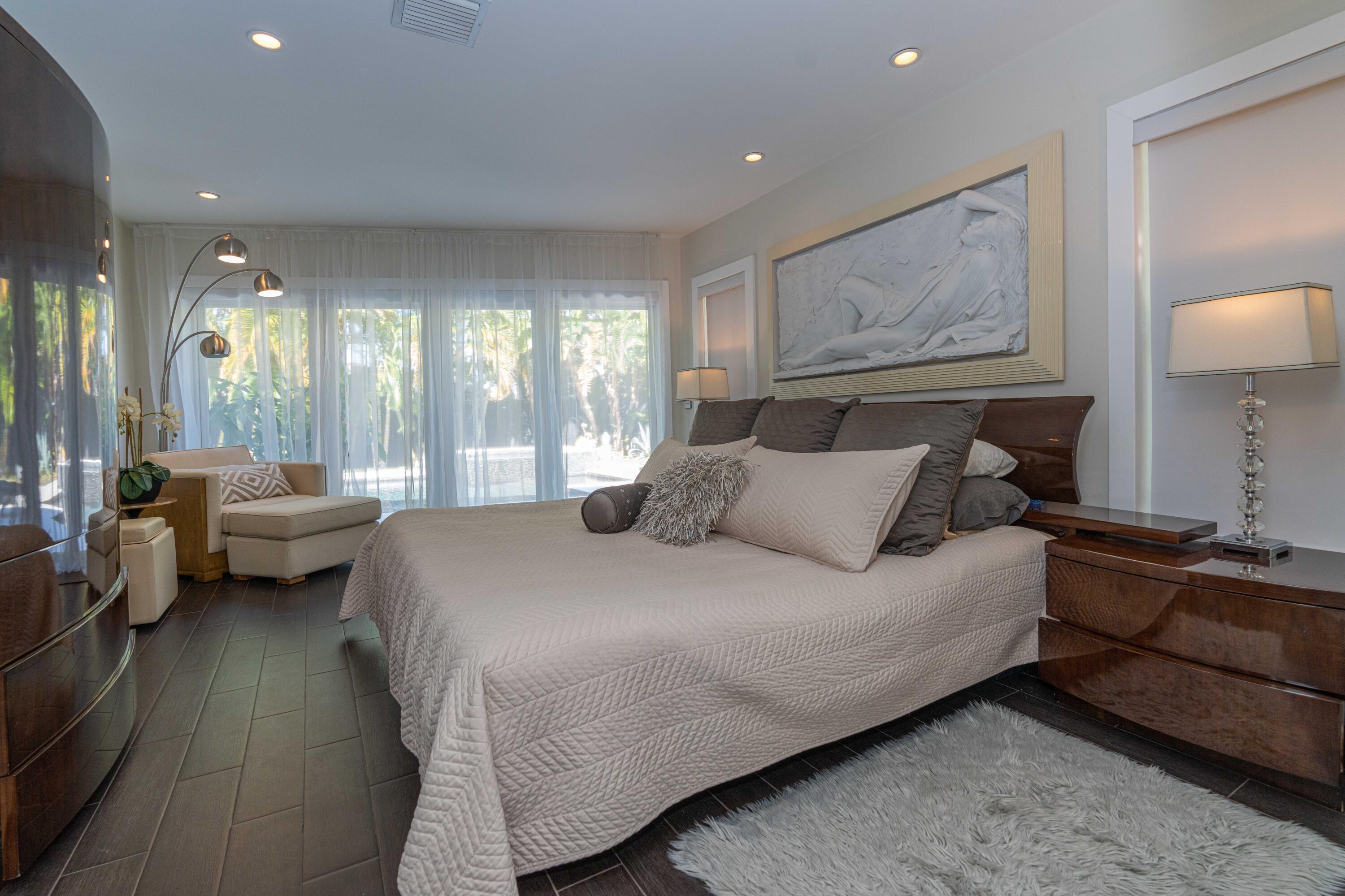 855 Berkley Street Boca Raton, FL 33487 - Photo 15 of 31 a spacious bedroom with a bed and glass windows