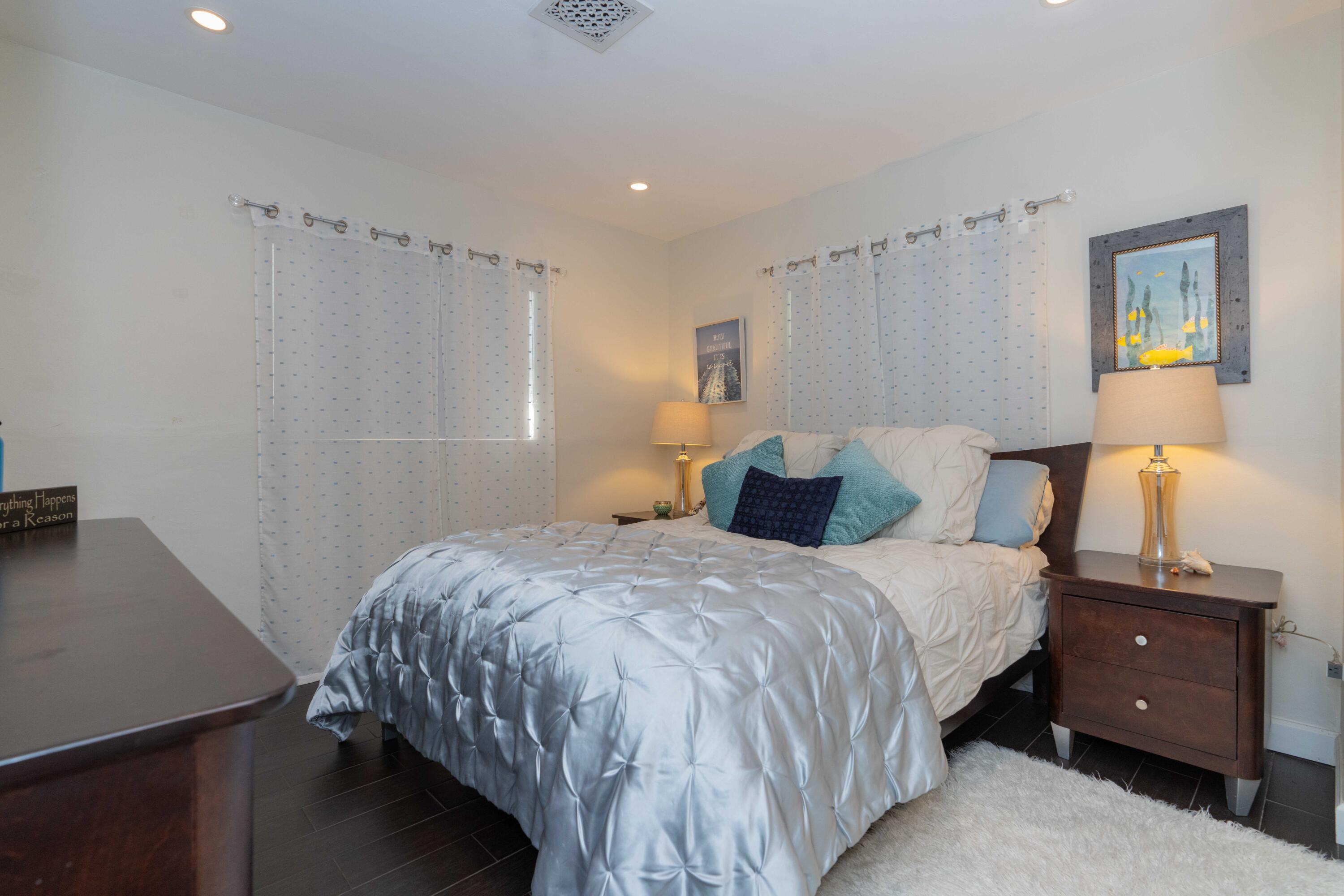 855 Berkley Street Boca Raton, FL 33487 - Photo 19 of 31 a bedroom with a bed and a night stand