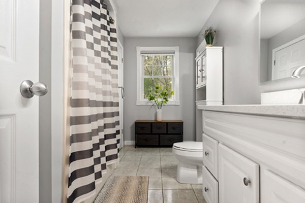 980 North Main Street Raynham, MA 02767 - Photo 12 of 29 a bathroom with a sink a toilet a window and shower