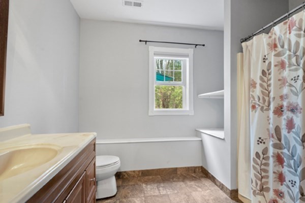 980 North Main Street Raynham, MA 02767 - Photo 19 of 29 a bathroom with a granite countertop toilet a sink and a bathtub