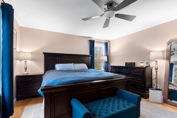 980 North Main Street Raynham, MA 02767 - Photo 9 of 29 a bedroom with a bed and a chandelier