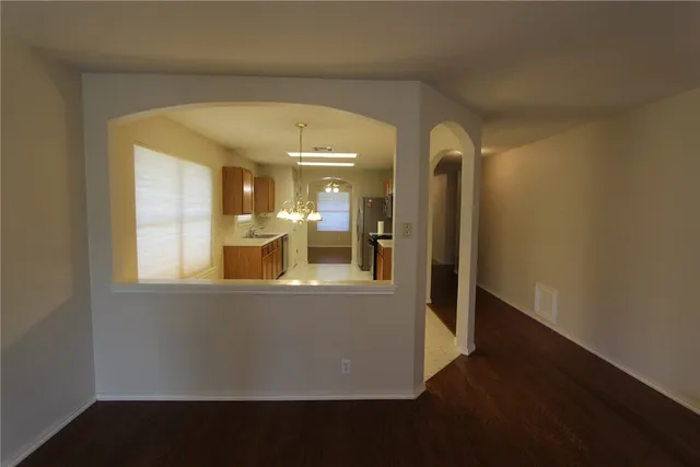 a view of a living room with wooden floor and a large window