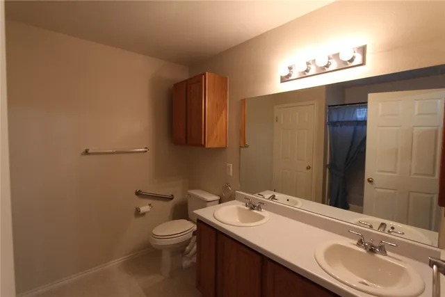 a bathroom with a shower toilet and sink