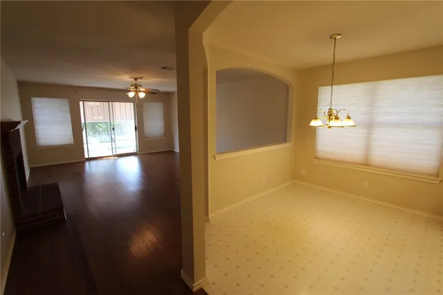 a view of a room with wooden floor and a window