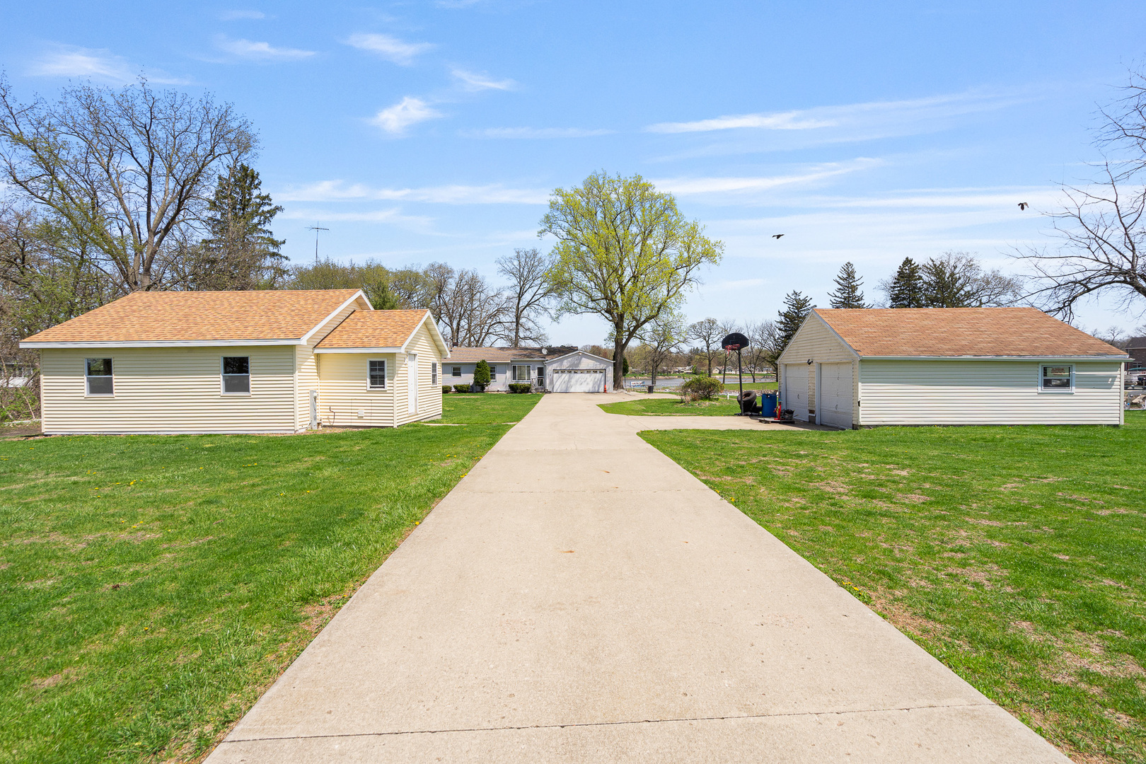 a view of house with garden and tall trees