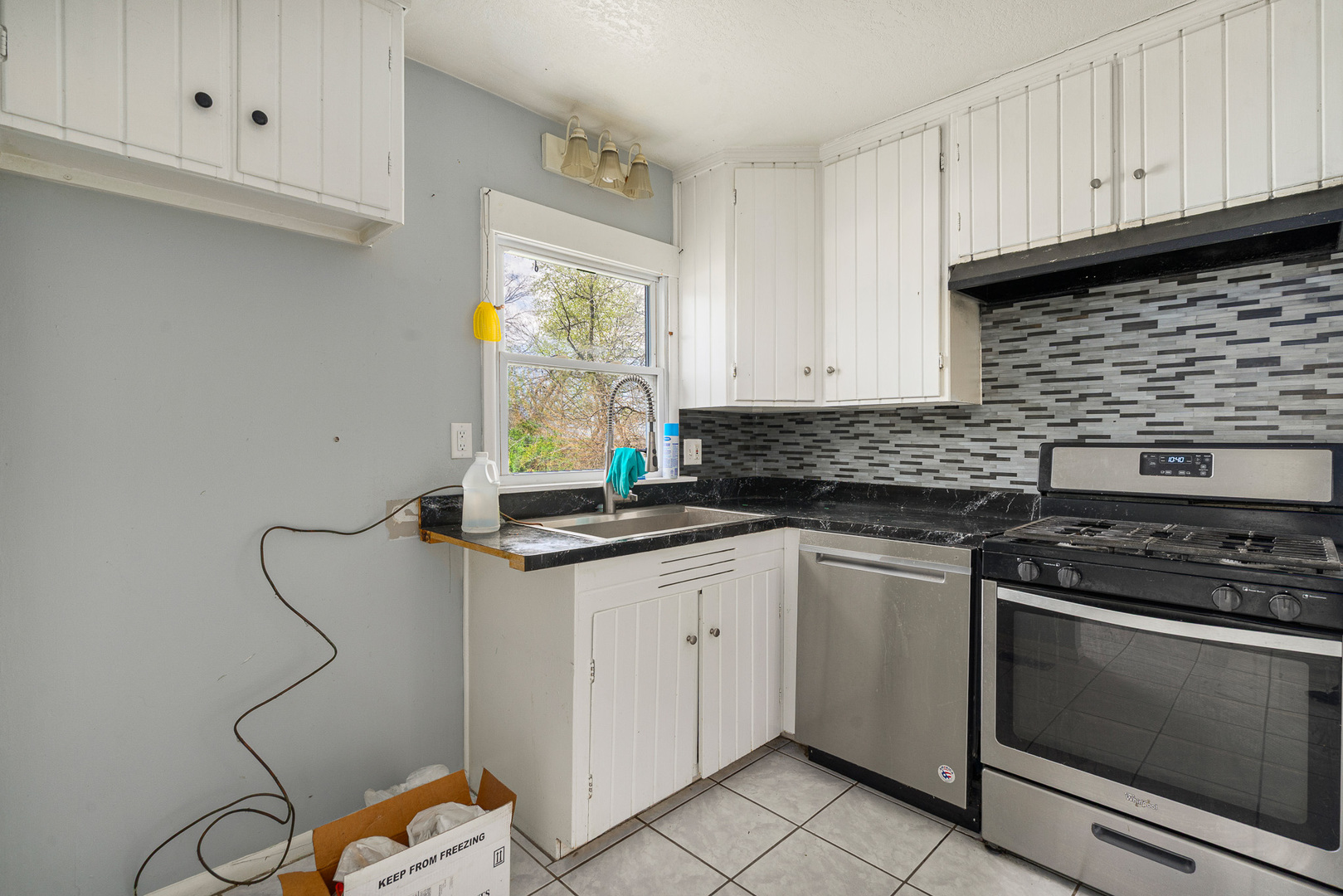 2697 River Road Kankakee, IL 60901 - Photo 13 of 60 a kitchen with granite countertop white cabinets stainless steel appliances and a sink