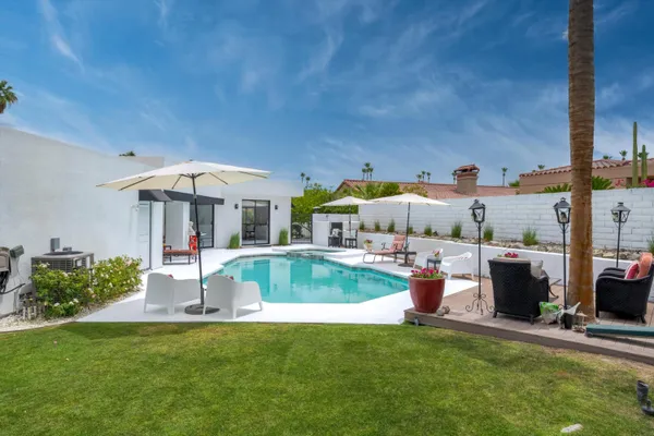 a view of a swimming pool with a patio