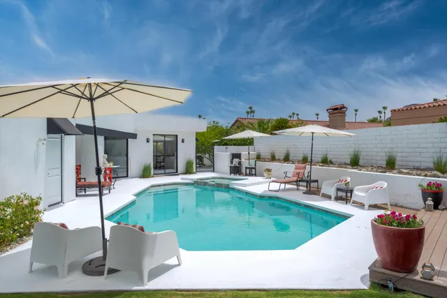 a view of a swimming pool with outdoor seating