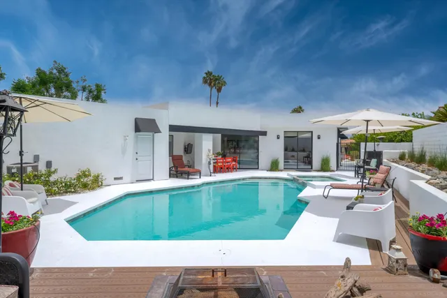 a view of a backyard with furniture