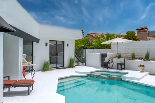 a view of a swimming pool with a patio