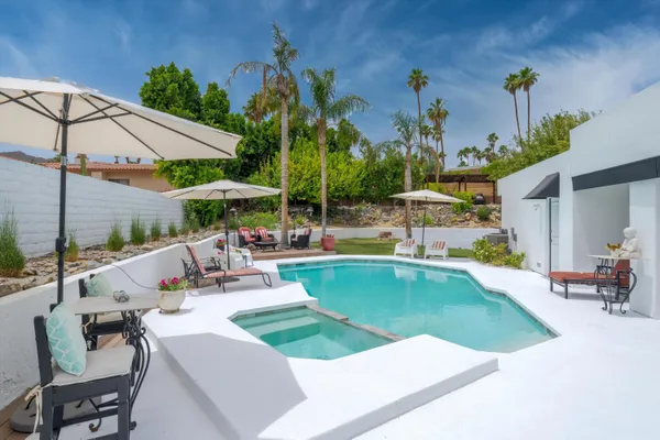 a view of a backyard with sitting area