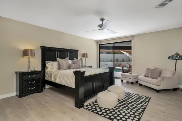 a bedroom with a bed and a large mirror with a flat tv screen