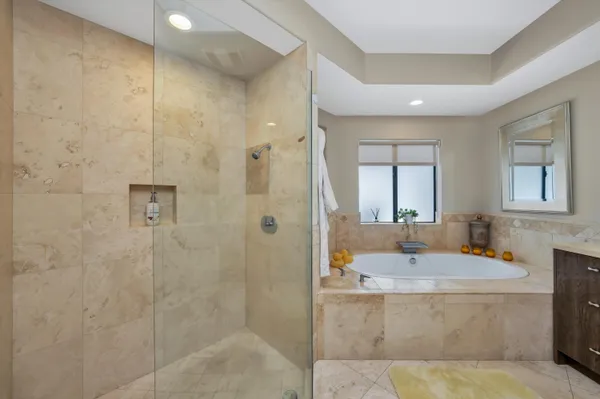 a bathroom with double vanity and a mirror