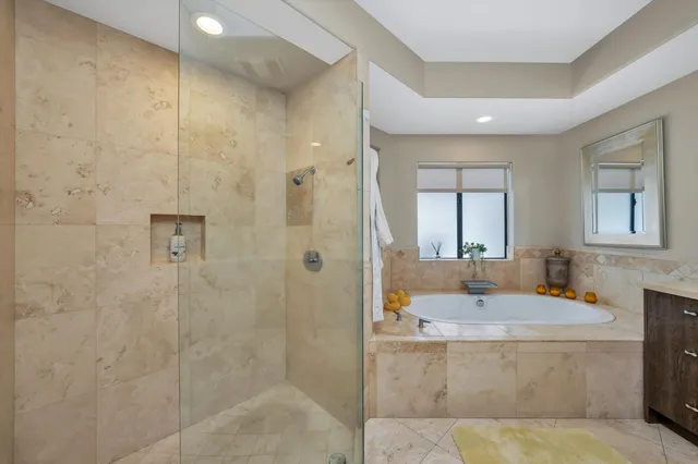 a bathroom with double vanity and a mirror