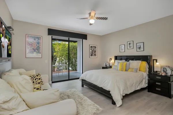 a bed room with a bed and a painting on the wall