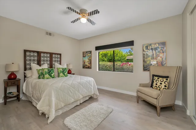 a bathroom with a granite countertop sink a mirror and a toilet