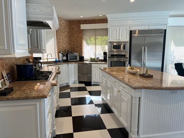a kitchen with counter top space appliances and cabinets