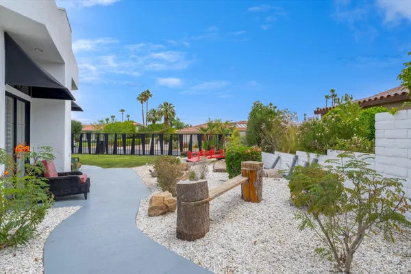 a view of a backyard with sitting area