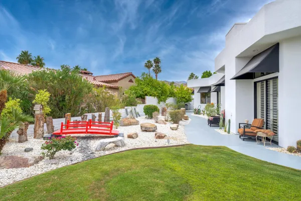 a view of a house with backyard porch and sitting area