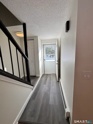 a view of an entryway with wooden floor