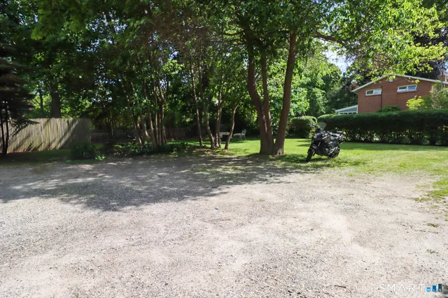 a view of a house with a yard and pathway