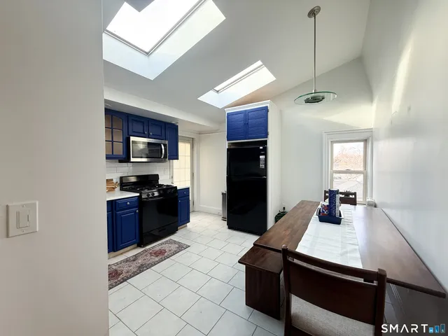 a kitchen with kitchen island a counter space cabinets and stainless steel appliances