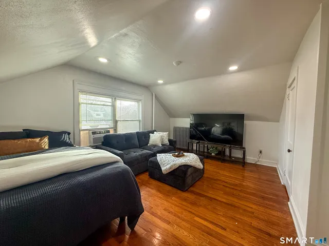 a room with a bed a television and a couch