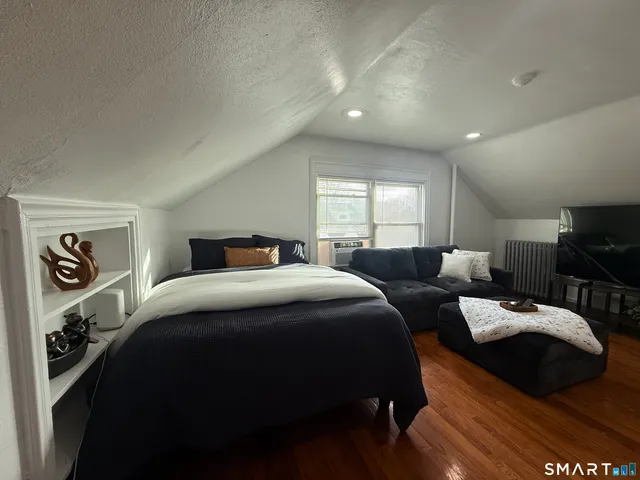 a bedroom with a bed and a view of kitchen