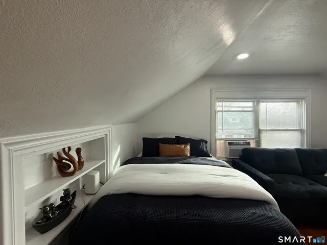 a bedroom with a bed and window