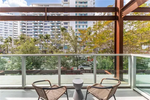 a view of a chairs and table in the balcony