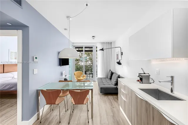 a kitchen with stainless steel appliances kitchen island granite countertop a sink and a refrigerator