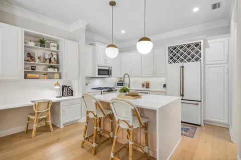 a view of a kitchen with a table and chairs