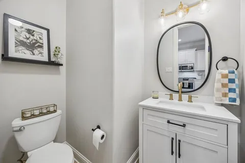 a bathroom with a toilet a sink and a mirror