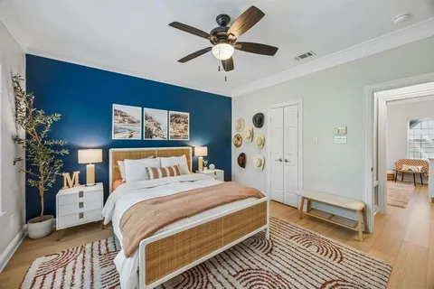 a bedroom with a bed and a chandelier