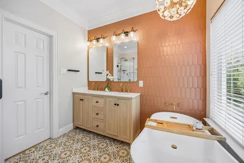 a spacious bathroom with a large tub and sink