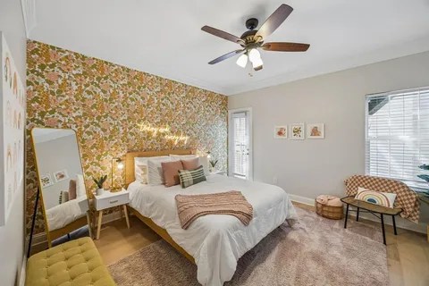 a bedroom with a large bed and a flat screen tv