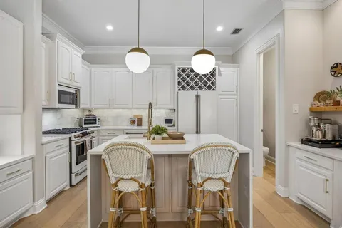 a view of a dining room and kitchen with a table chairs