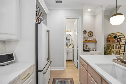 a kitchen with granite countertop a sink stove and refrigerator