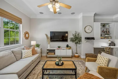 a living room with furniture a rug and a large window