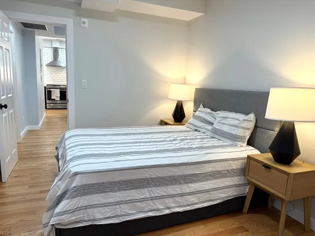 a bedroom with a bed and lamp