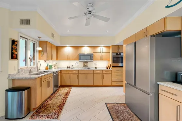 a kitchen with granite countertop a sink and cabinets
